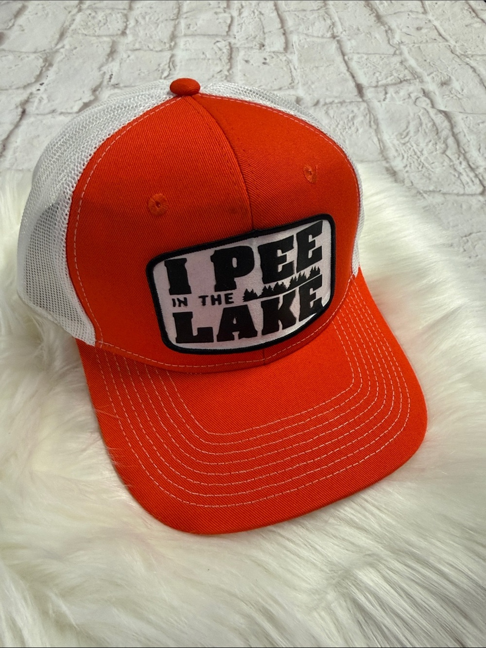 Port Authority Orange and White Trucker Hat with 'I Pee In The Lake' Patch